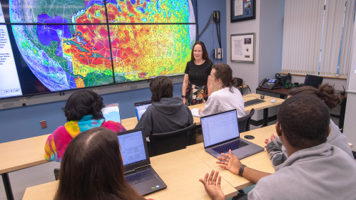 Associate Professor Grace Saba leads a discussion with students in the RUCOOL Operations Center