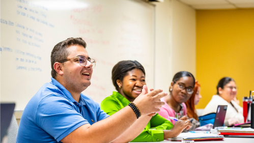 Students in a classroom smiling