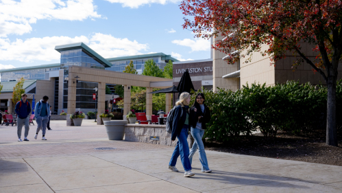 Students walk outside the Student Center on Livingston campus on a fall day