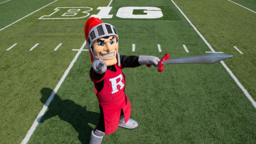 Scarlet Knight mascot poses on football field 