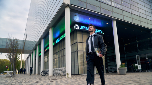 A student walking outside of the Business School