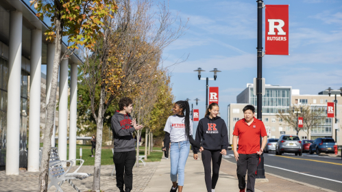 Matthew Garelick (RBS ’25), Ryann Sterling (RBS ’25), Alyssa Lomangino (RBS ’26), and Matthew Peyrek (RBS ’19) (GSE) walk along the Livingston campus on a warm fall day.