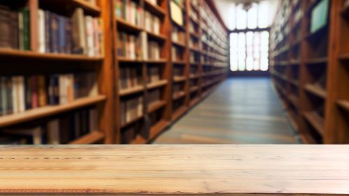 Image of wooden table in front of library shelves