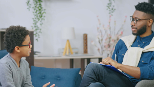 A school psychologist speaking with a student.