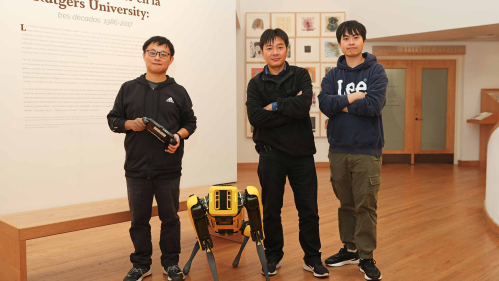 Fifth-year engineering student Chong Di (left), Professor Jie Gong and Shengyuan Feng, a graduate student studying artificial intelligence, pose with Echo the robot in the Zimmerli Art Museum.