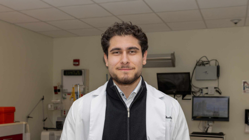 Omar M. Abuattieh stands in a lab room in the Ernest Mario School of Pharmacy.