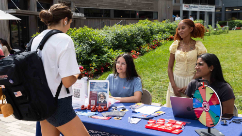 A student talks with Tesia Yachimovicz (second from left), Monica Dunkerson and Tania Saravanakumar at The Yard.