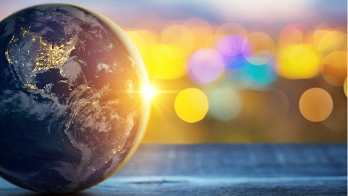 Globe of earth at left with sun sparkles to the right