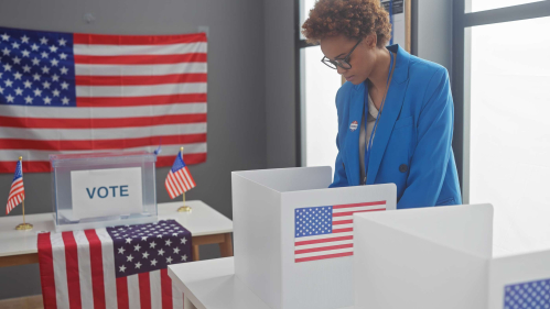 A woman casts her ballot at a voting center.