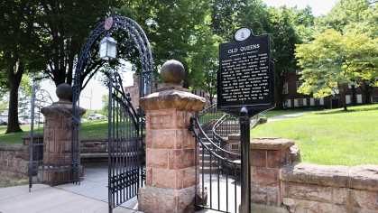 Signage of Old Queens near Class of 1902 gate on Hamilton Street on the College Avenue campus