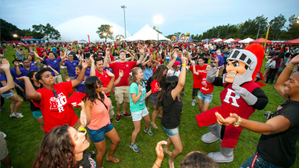students with the Knight outside dancing