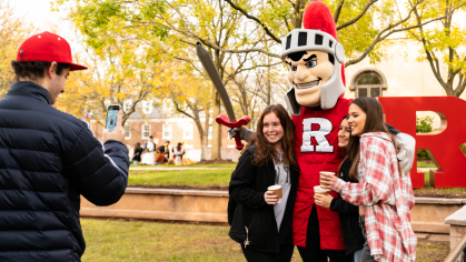Students taking a picture with the Scarlet Knight mascot