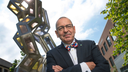 Photo of Stephen Burley in front of a large metal collagen structure