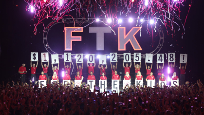 Students hold up the fundraising total during the annual dance marathon