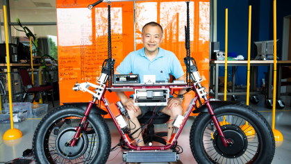 A Rutgers engineering researcher with a robot