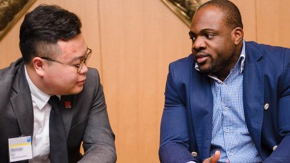 A student and mentor talk in a conference room