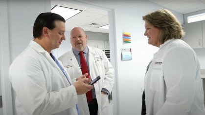 NJMS transplant team physicians talk outside of an exam room at University Hospital