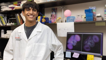 A student posing in a lab