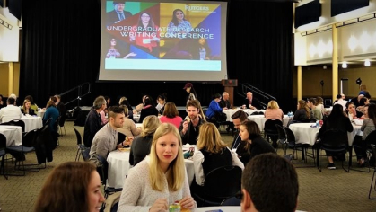 Students sitting at tables at the Undergraduate Research Writing Conference