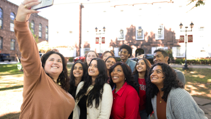Chancellor Fran Conway taking a selfie with students.