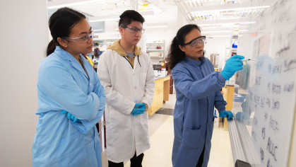students and faculty in a lab