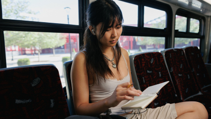 female student riding on a bus
