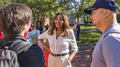 Chancellor Conway speaking to a student wearing a backpack during move-in 2026
