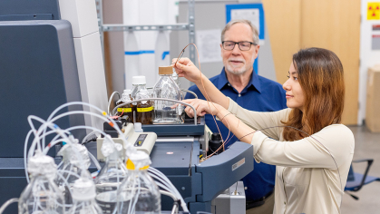 A student and faculty member performing an experiment