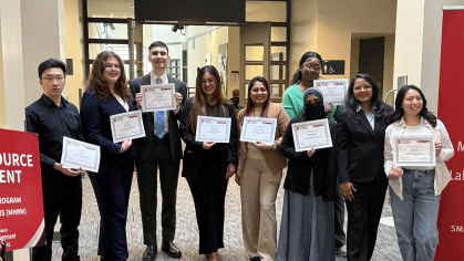 A group of students holding awards