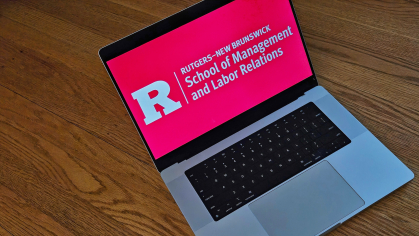 A laptop with the Rutgers School of Management and Labor Relations logo on the screen