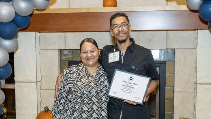 Jonathan Lopez and his mother at the Tri-Alpha Induction Ceremony
