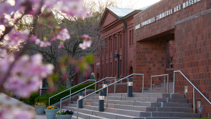 The stairs in front of the entrance of the Zimmerli Art Museum with flowers blurred in the foreground
