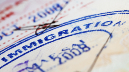 A photo of a passport with the words "Immigration" on it