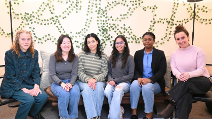 a group of students sitting on a couch in a wellness room