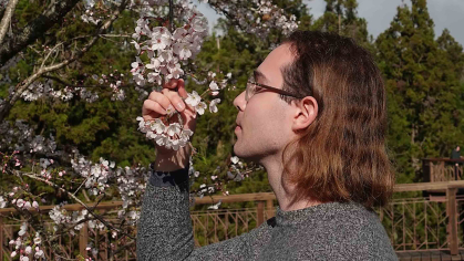Rutgers graduate Evan Charles Keeton takes in the cherry blossoms at the Alishan National Forest Recreation Area in Taiwan.
