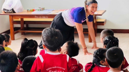 Chelsea A. Fernandez, a Rutgers graduate and Fulbright grant recipient, plays animal charades for school children in Thailand.