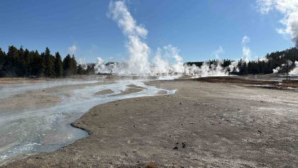 Geysers erupt in a moon-like landscape