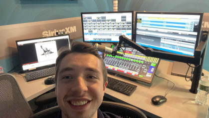 Rutgers senior Eddie Kalegi sits in front of a radio board at SiriusXM's headquarters in New York.