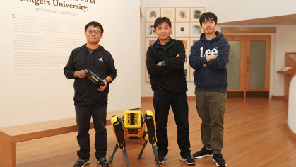 Fifth-year engineering student Chong Di (left), Professor Jie Gong and Shengyuan Feng, a graduate student studying artificial intelligence, pose with Echo the robot in the Zimmerli Art Museum.
