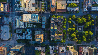 Aerial view of city with parks interspersed