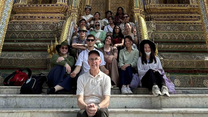 Rutgers professor Mark Robson (front) and his students pose for a group shot at the Grand Place in Bangkok.