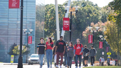 Students walk on sidewalk near the Rutgers Business School on Livingston campus in this October 2021 photo.