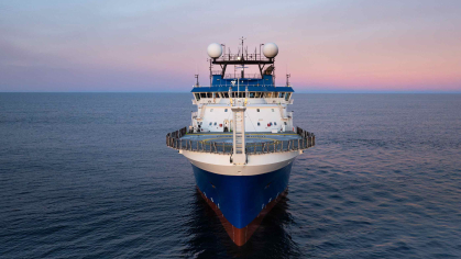 Research vessel facing the camera head on, with bow in front.