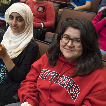Two students sit in a lecture hall
