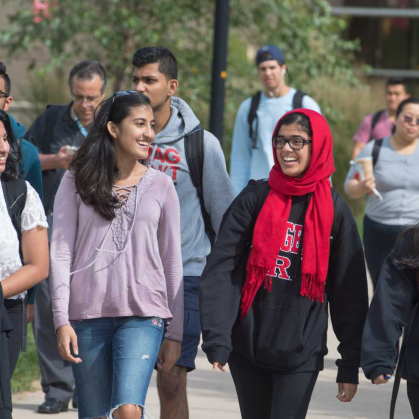 Students walking and smiling on campus