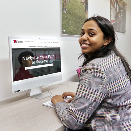 Student sitting at a desk with a computer with the Success website on the screen