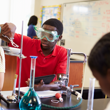 High school students conducting an experiment in science class