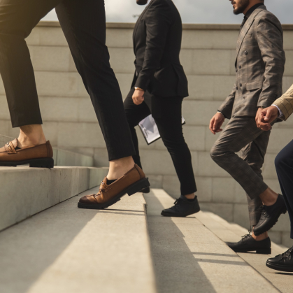 Business people climbing stairs