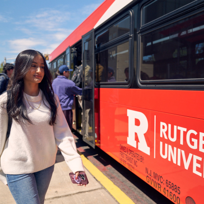 female student walking toward a bus