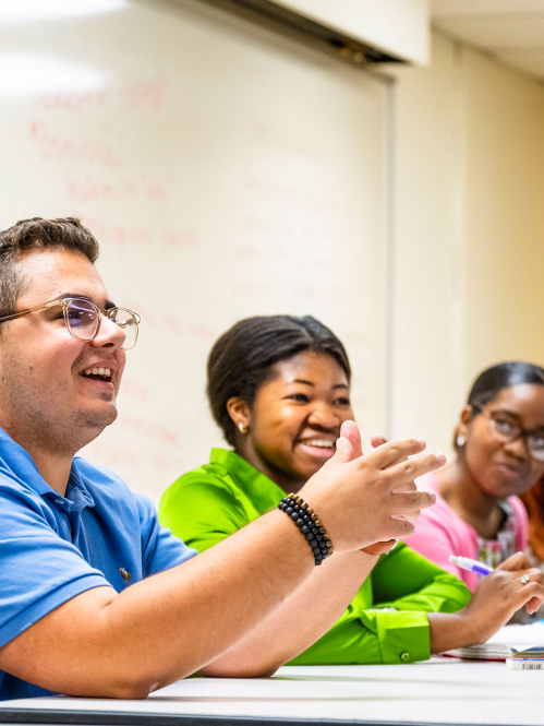 Students in a classroom smiling